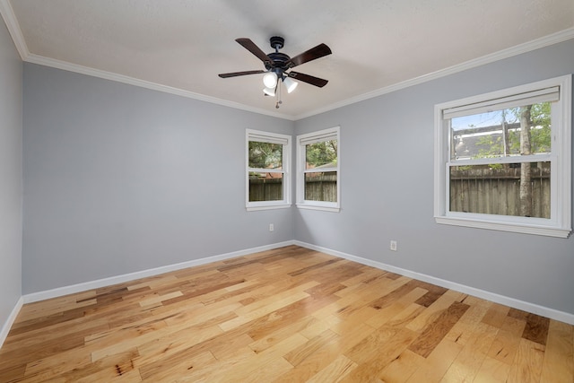 unfurnished room with crown molding, a healthy amount of sunlight, and light hardwood / wood-style floors