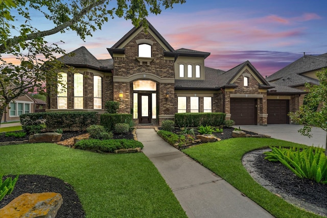 view of front of house with a lawn and a garage