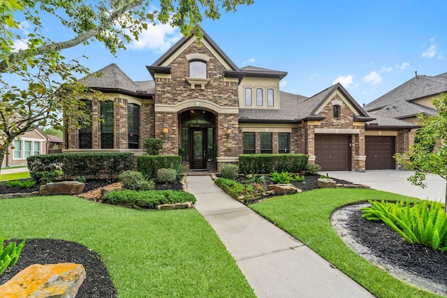 view of front of property with a front yard and a garage