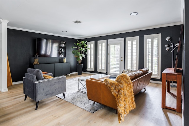 living room featuring crown molding and light hardwood / wood-style floors