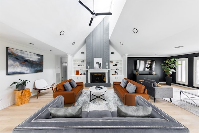 living room with built in shelves, light wood-type flooring, high vaulted ceiling, and ceiling fan