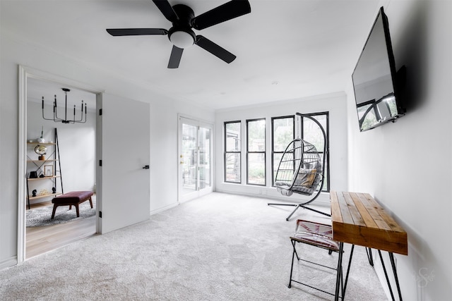 living area with light carpet, ceiling fan, and ornamental molding