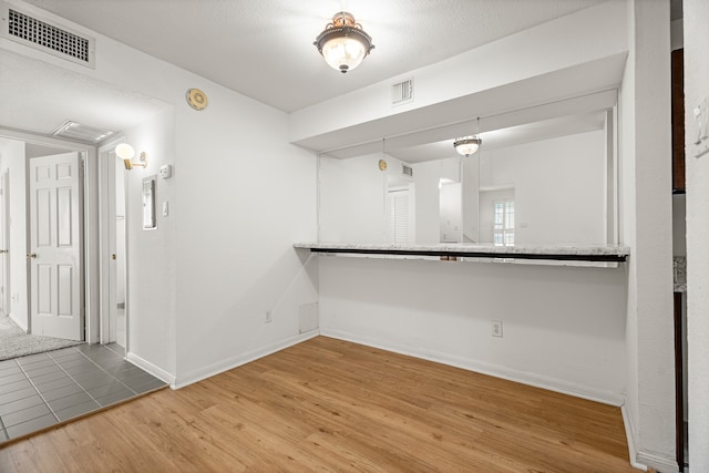 spare room with wood-type flooring and a textured ceiling