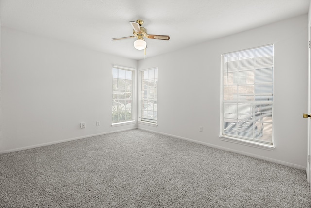 carpeted empty room featuring ceiling fan