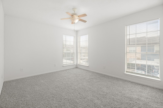 spare room with carpet and ceiling fan