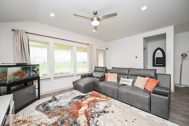 living room featuring hardwood / wood-style floors, vaulted ceiling, and ceiling fan