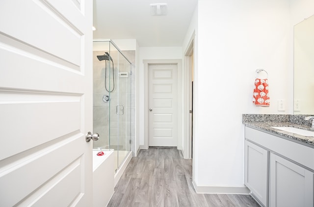 bathroom with vanity, wood-type flooring, and separate shower and tub