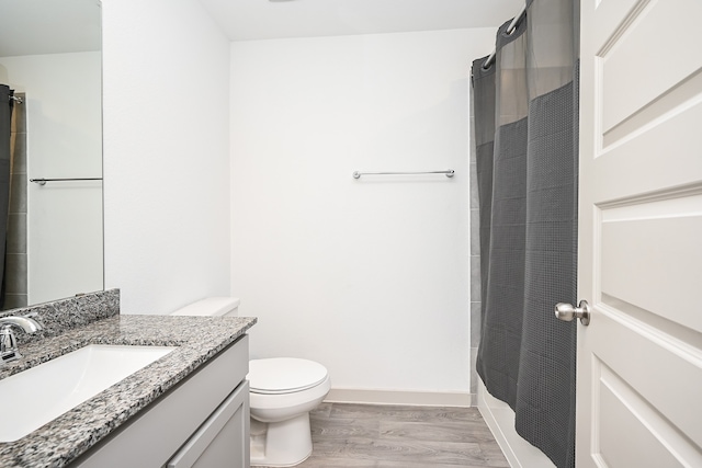 full bathroom featuring wood-type flooring, vanity, toilet, and shower / bathtub combination with curtain