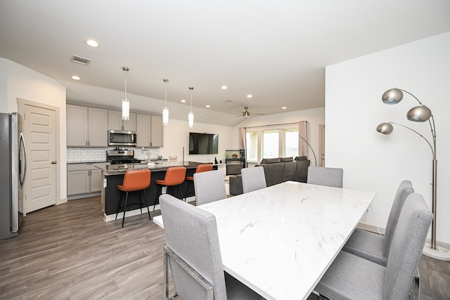 dining area featuring ceiling fan and light hardwood / wood-style flooring