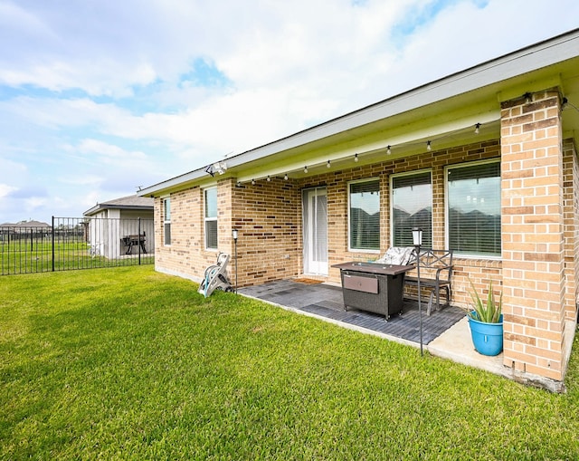 rear view of property featuring a lawn and a patio