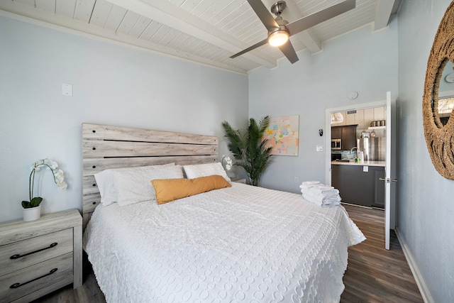 bedroom featuring dark wood-type flooring, ceiling fan, and beam ceiling