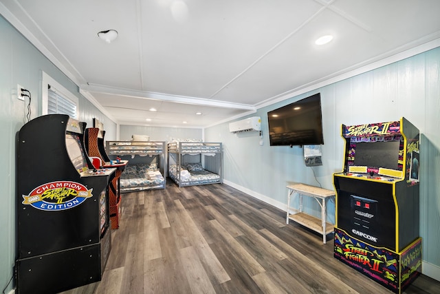 playroom featuring hardwood / wood-style floors and a wall mounted air conditioner