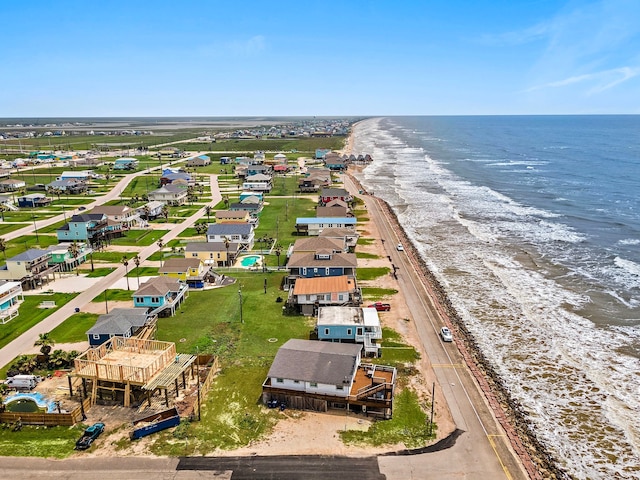 birds eye view of property featuring a water view and a beach view