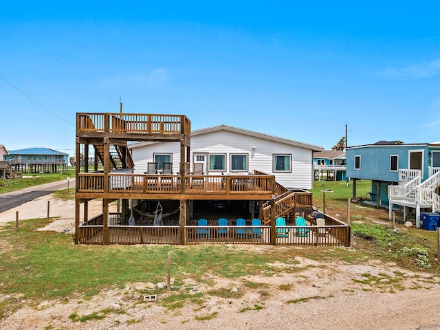 rear view of house featuring a wooden deck