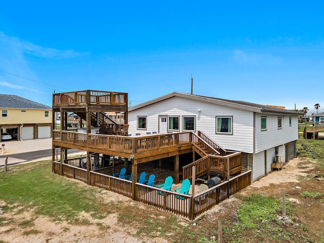 back of house featuring a garage and a wooden deck