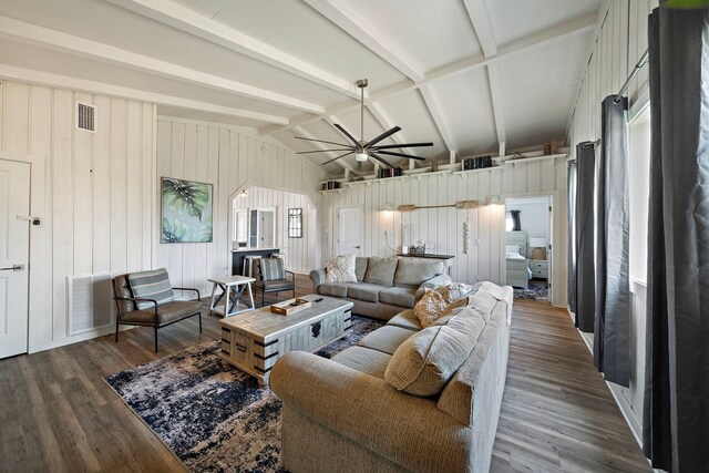 living room with wood walls, ceiling fan, dark hardwood / wood-style flooring, and lofted ceiling with beams