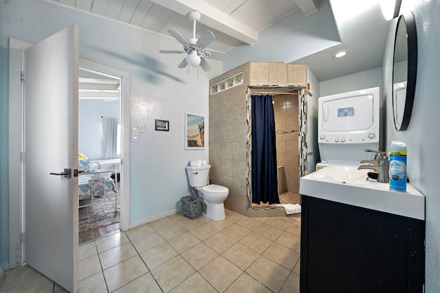 bathroom featuring vanity, tile patterned flooring, toilet, and stacked washer / drying machine