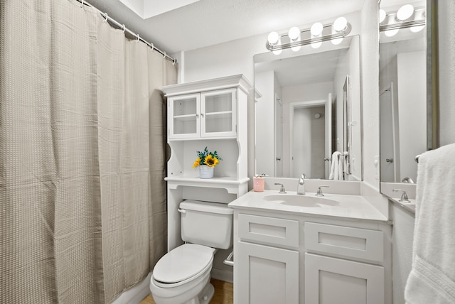 bathroom with vanity, toilet, and a shower with curtain