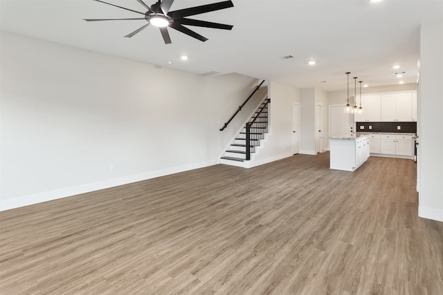 unfurnished living room with ceiling fan and light hardwood / wood-style floors