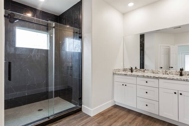 bathroom with vanity, hardwood / wood-style floors, and a shower with shower door