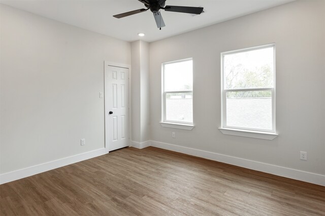 empty room featuring hardwood / wood-style floors and ceiling fan