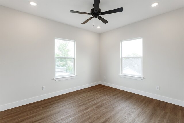 empty room featuring dark wood-type flooring and ceiling fan