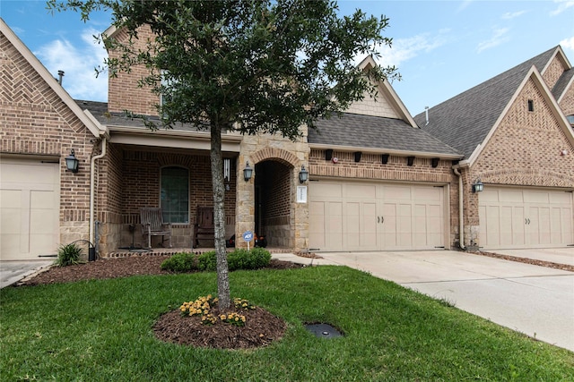 view of front of house featuring a garage, a front yard, and a porch