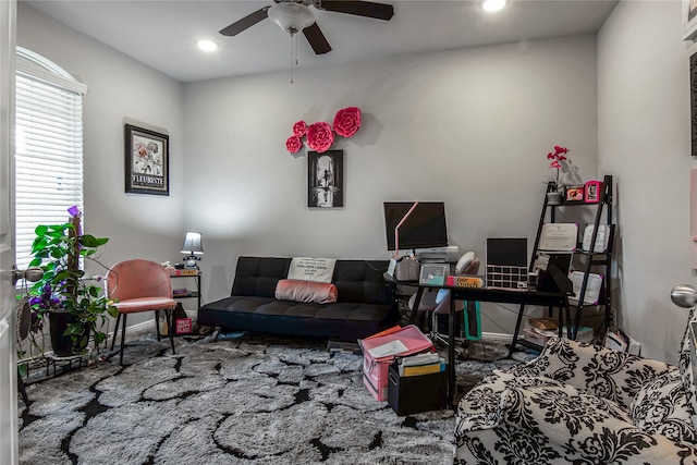 carpeted living room featuring ceiling fan