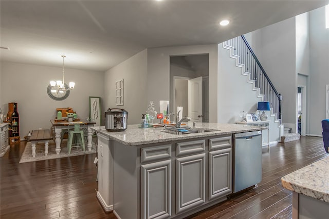 kitchen with sink, decorative light fixtures, stainless steel dishwasher, an island with sink, and dark wood-type flooring