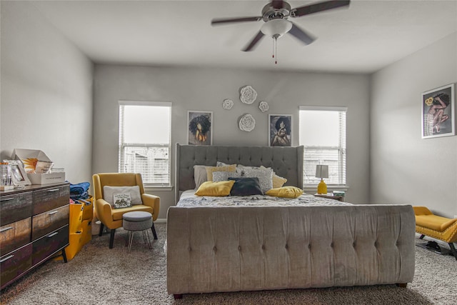 carpeted bedroom featuring ceiling fan and multiple windows