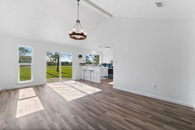 unfurnished living room with vaulted ceiling with beams, dark hardwood / wood-style floors, and a notable chandelier