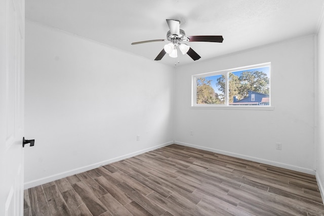 unfurnished room featuring hardwood / wood-style flooring, ceiling fan, and ornamental molding