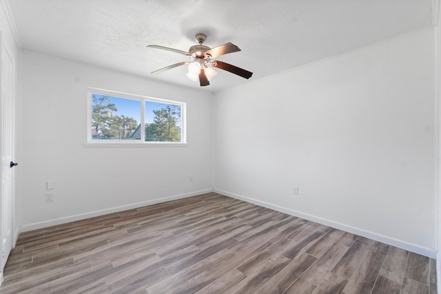 unfurnished room with ceiling fan, ornamental molding, and light wood-type flooring