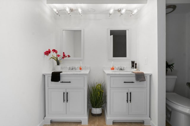 bathroom featuring tile patterned floors, vanity, and toilet