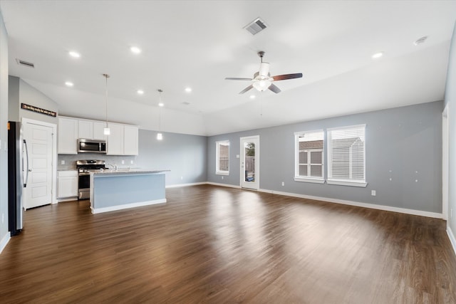 unfurnished living room with dark hardwood / wood-style flooring, ceiling fan, and vaulted ceiling