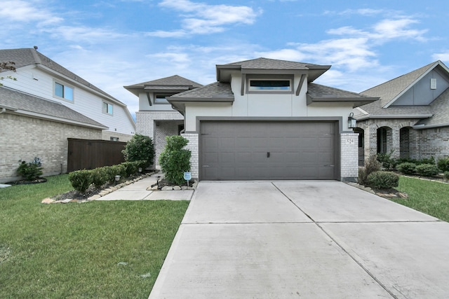 view of front of property featuring a front lawn and a garage