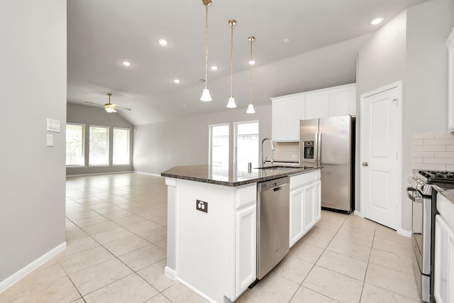 kitchen featuring decorative backsplash, sink, a kitchen island with sink, white cabinetry, and appliances with stainless steel finishes