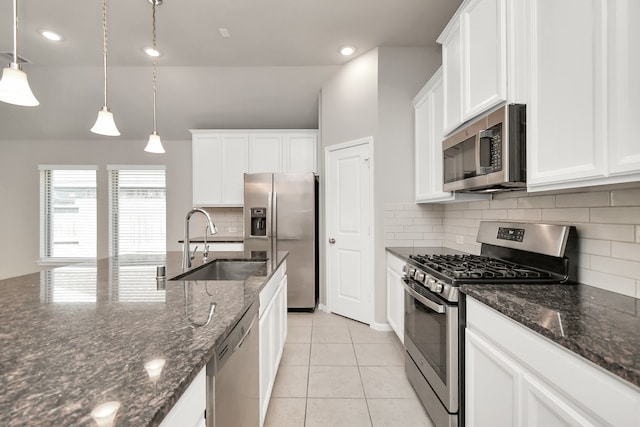 kitchen with stainless steel appliances, white cabinets, sink, and pendant lighting