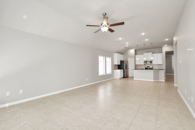 unfurnished living room featuring ceiling fan, vaulted ceiling, and light tile patterned floors