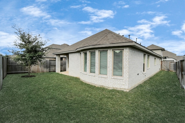 view of side of home featuring a lawn