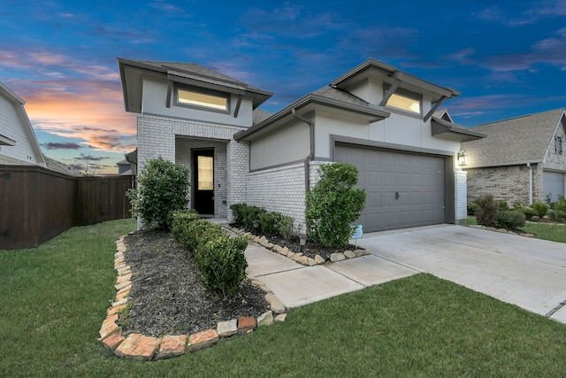 view of front of house with a garage and a yard