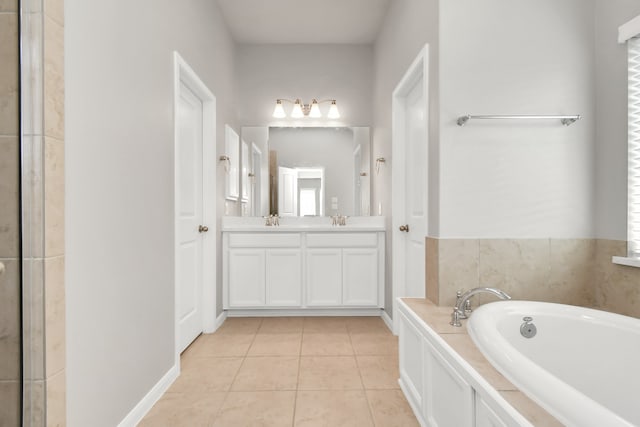 bathroom with tile patterned floors, vanity, and a bathing tub