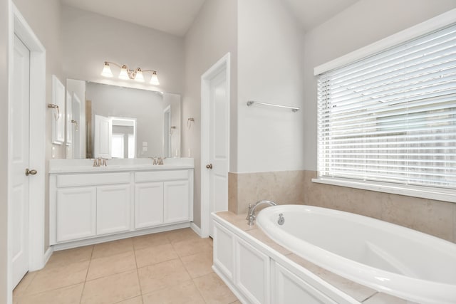 bathroom featuring a tub to relax in, vanity, and tile patterned floors