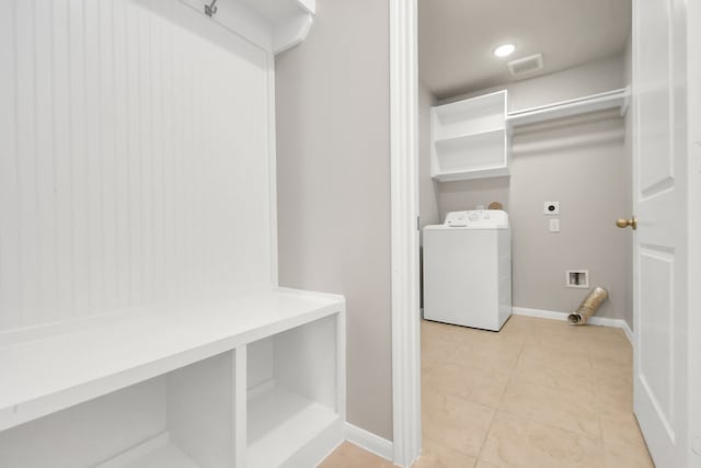 laundry area featuring light tile patterned floors and washer / dryer