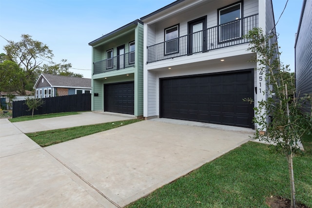 view of front of property featuring a garage and a balcony