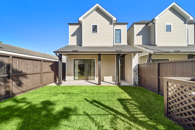 back of house featuring a patio and a lawn