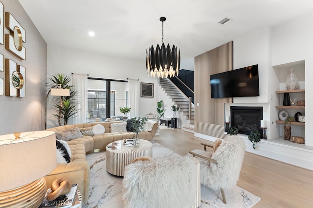 living room with light hardwood / wood-style flooring and a notable chandelier