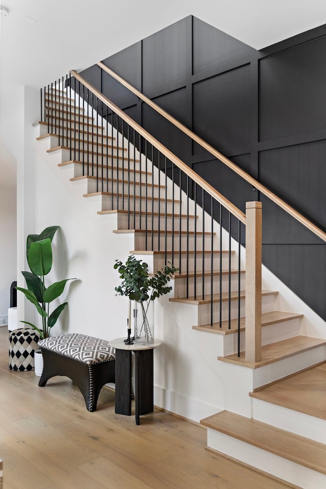 staircase with wood-type flooring