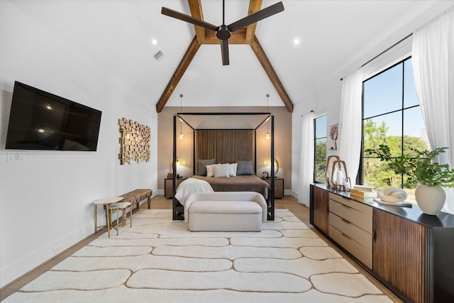 bedroom with beam ceiling, light hardwood / wood-style flooring, and high vaulted ceiling