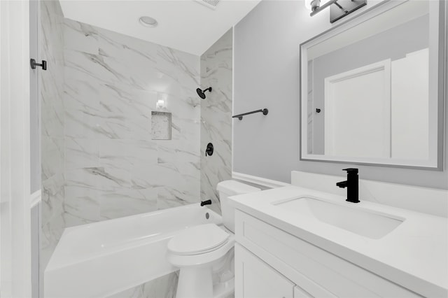 full bathroom featuring vanity, tiled shower / bath combo, and toilet